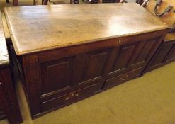 An 18th Century Oak Mule Chest of typical form, hinged lid, void interior, four panelled front to