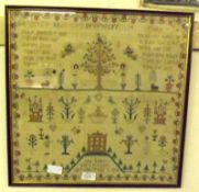 An early 19th Century Needlework Sampler of typical form with rows of religious text, letters and