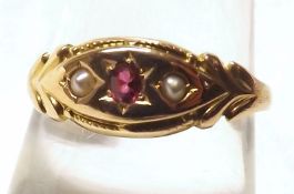 A late Victorian hallmarked 18ct Gold Ring, set with a centre small oval Red Stone and two Seed