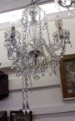 A large 20th Century Six Arm Chandelier decorated with extensive prismatic drops