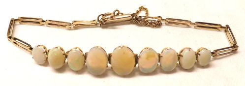 A yellow metal Link Bracelet, the articulated front featuring nine graduated Oval Opals