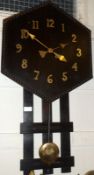 An early 20th Century Continental stained Oak Wall Clock, the hexagonal surround with beaded rim, to