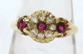 An 18ct Gold hallmarked Ring set with three red stones and small Diamonds