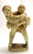 A small Carved Ivory Figure Group of a Japanese erotic couple, 2” high