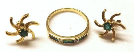 A high grade precious metal Half Hoop Ring set with six small Emeralds and two small Brilliant Cut
