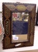 A small Middle Eastern Wall Mirror, the frame inlaid with intricate geometric designs, 10” wide