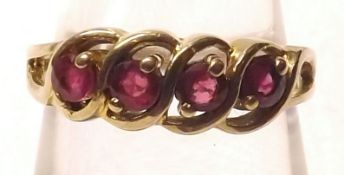 A hallmarked 9ct Gold Ring set with a group of four red stones