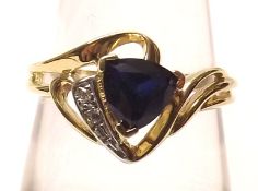 A yellow metal Ring marked 10K set with blue stone and Diamond chips