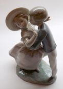 A large Lladro Figure Group of young lovers, raised on a plinth base, numbered to base K13M, 9 ½”