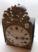A late 19th Century French Comtoise Wall Clock of typical form with embossed brass mask decorated