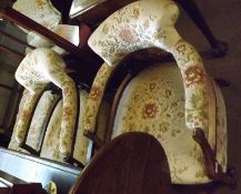 A pair of late 19th/early 20th Century Bow Back Armchairs, upholstered in floral fabric, the backs