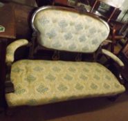 A Victorian Walnut Sofa, oval back crested with a floral moulded pediment and raised on short lyre