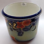 A Wilkinson Limited Oxford pattern Jardinière, decorated with flowers on a blue background, 9”