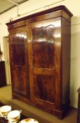 A large 19th Century Mahogany Wardrobe, the moulded cornice to two large panelled doors, the