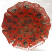 An Oriental Plate of octagonal form, the centre and gilded and decorated in famille noir on an