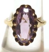A yellow metal Ring marked 9ct set with a single oval purple stone