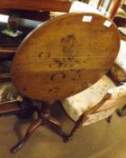 A 19th Century Oak Circular Snap Top Table, raised on a turned pedestal to a spreading tripod