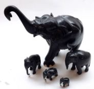 A group of five early 20th Century Ebony Elephants, some with losses to tusks etc, largest 10” high