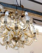 A 20th Century Six Arm Chandelier decorated with extensive prismatic drops