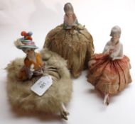 A group of three early 20th Century Pin Cushion Dolls, of typical form, two with ceramic legs,