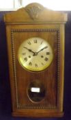 A mid 20th Century stained Walnut Wall Clock, ,the rectangular case with shaped pediment, hinged