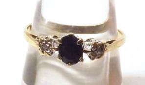 A hallmarked 9ct Gold Ring set with central Coloured Diamond, flanked on either side by a small