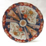 An Imari Circular Plate, decorated with a central spreading fan design, within a compartmentalised