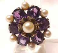 A large last quarter of the 20th Century six Purple Stone and seven Pearl Ring of flower head design