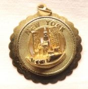 A yellow metal “New York” Commemorative Pendant marked 14K, weighing approximately 5 ½ gm