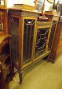 A late 19th/early 20th Century Mahogany Drop Centre Display Cabinet, decorated with fretwork and