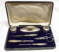 A George VI cased Manicure Set, comprising two small Silver topped Jars, Nail Buffer, three Nail