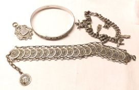 A mixed lot of white metal Jewellery, including Charm Bracelet; Engraved Bangle; Coin Bracelet and