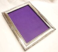 A George V rectangular Easel Backed Picture Frame of typical form, decorated with floral banding (