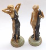 A pair of early 20th Century Composition Figures of Semi-Nude Ladies, raised on polished onyx bases,