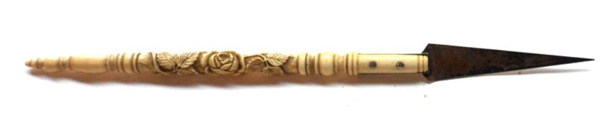 An Ivory-handled Pointer or Page Turner, the shaft carved with foliage, terminating in a steel