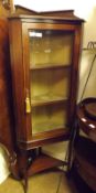 An Edwardian Mahogany Corner Cabinet with inlaid banding, fitted with single glazed door, raised