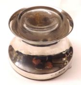 An Edward VII Small Desk Inkwell of waisted form, fitted with clear glass liner and a loaded base,