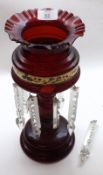 A Victorian Ruby Glass Lustre Vase with frilled rim, tapering stem with serpent detail, raised on