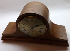 A mid-20th Century Oak Cased Triple Barrel Mantel Clock, the arched case on shaped pediment to a