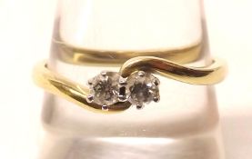 A hallmarked 18ct Gold two small Brilliant Cut Diamond Ring of crossover design