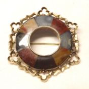 A late 19th/early 20th Century yellow metal framed Scottish Brooch of shaped circular form with