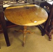 An early 19th Century Oak Snap Top Table, of typical form with round top, turned pedestal, raised on