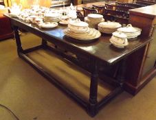 An 18th Century Oak Refectory Table, three plank top, raised on four turned legs to a stretcher