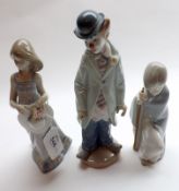 A group of three Lladro Figures, young girl with hat; young boy in cloak; and a clown (slight A/