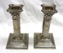 A pair of George V small Candlesticks, fitted with gadrooned removable nozzles, the ribbed column