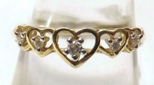 A hallmarked 9ct Gold Ring, featuring five small Brilliant Cut Diamonds to graduated open heart