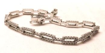A mid-grade precious metal Articulated Rectangular Link Bracelet, set throughout with small
