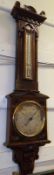 A late Victorian Combination Thermometer and Aneroid Barometer, in carved oak architectural case,