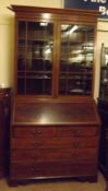 An Edwardian Mahogany Bureau Bookcase Cabinet, the top section with two glazed doors to interior