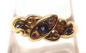 An Edwardian hallmarked 18ct Gold Ring set with three small Pale Blue Sapphires and two (of four)